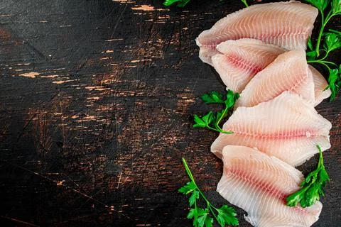 Raw fish fillet with parsley. Stock Photos