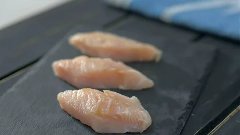 Raw fish fillets on black stone Stock Footage 111971075