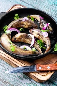 Raw fish in the pan Stock Photos