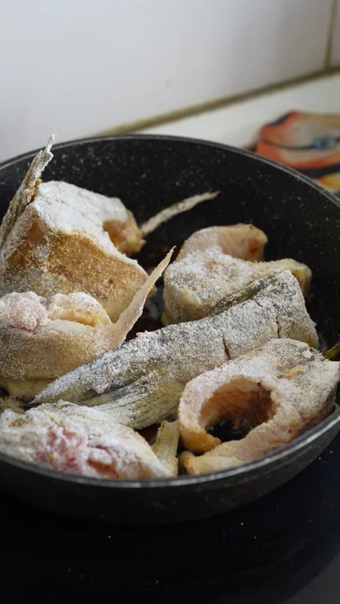 Raw fish steaks and a tail portion coated in flour Stock Footage 344783636