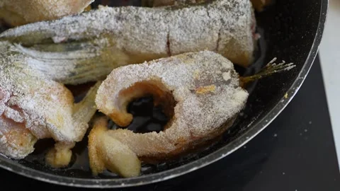 Raw fish steaks and a tail portion coated in flour Stock Footage 344784048