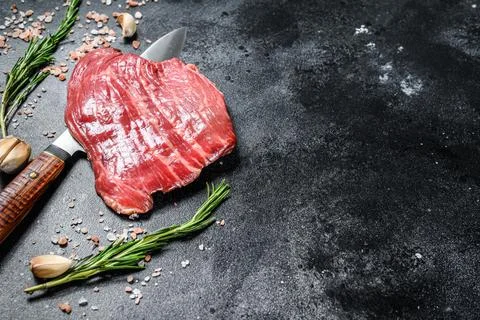Raw Flat Iron steak black Angus. Fresh Marble beef meat. Black background. Top Stock Photos