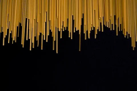 Raw flat spaghetti on black background Stock Photos