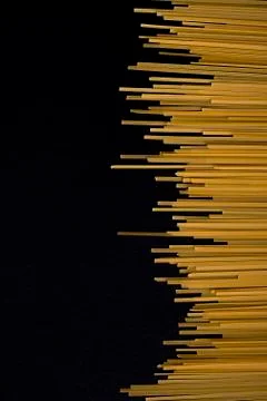 Raw flat spaghetti on black background Stock Photos