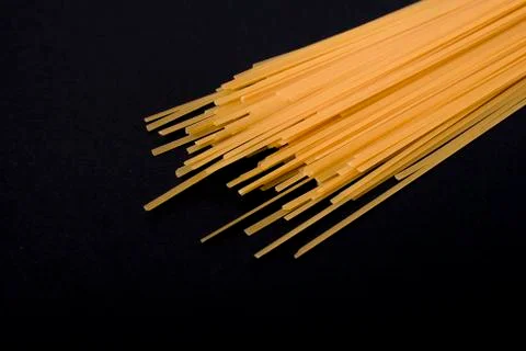 Raw flat spaghetti on black background Stock Photos