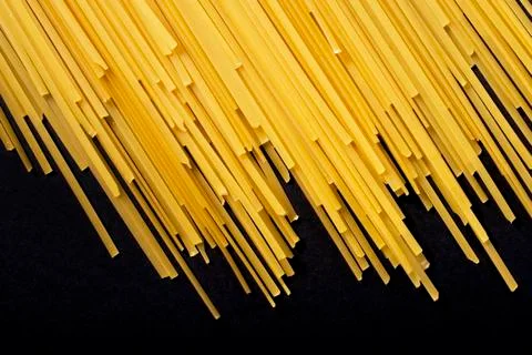Raw flat spaghetti on black background Stock Photos
