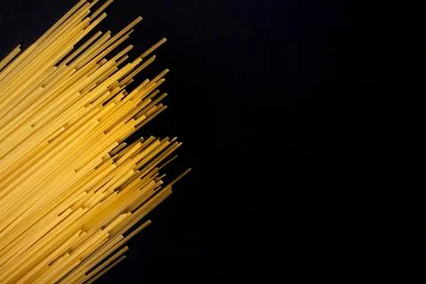 Raw flat spaghetti on black background Stock Photos