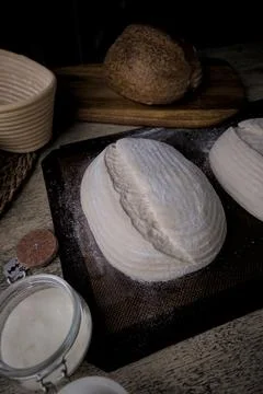 Raw Fresh artisan bread dough ready to bake on a Rustic Wooden Table. Stockfoto's