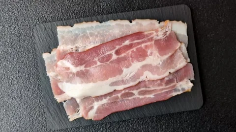 Raw fresh bacon slices with layers of meat or prosciutto with salt and spices Video stock 335377778