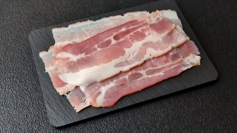 Raw fresh bacon slices with layers of meat or prosciutto with salt and spices Stock-Footage 335377802