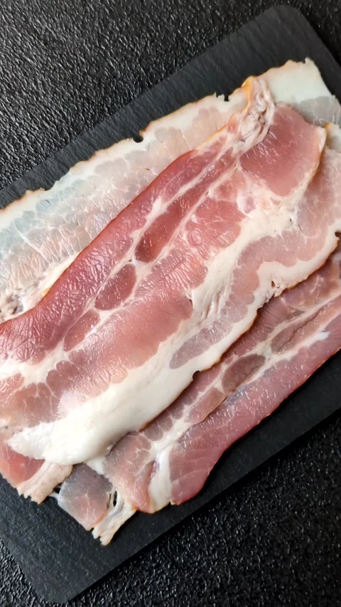 Raw fresh bacon slices with layers of meat or prosciutto with salt and spices Stock-Footage 335377803