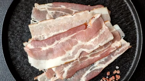 Raw fresh bacon slices with layers of meat or prosciutto with salt and spices Stock-Footage 335377894