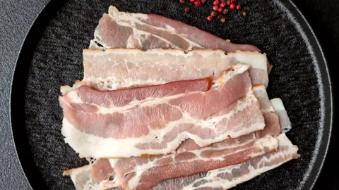 Raw fresh bacon slices with layers of meat or prosciutto with salt and spices Stock-Footage 335377900