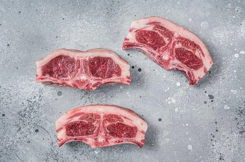 Raw fresh meat lamb mutton saddle. Gray background. Top view Stock Photos