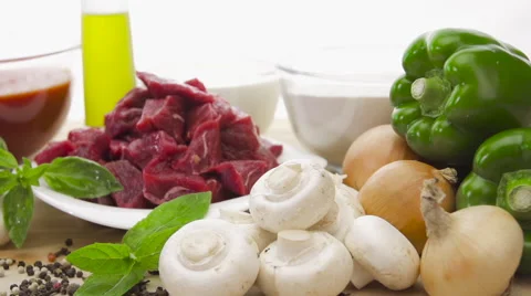 Raw fresh meat sliced in cubes on board with vegetables Stock Footage 54398685