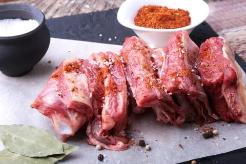 Raw fresh meat, uncooked lamb or beef ribs with pepper, garlic, salt and spices Stock Photos