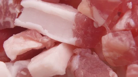 Raw fresh pork meat chunks on board, macro shot Stock Footage 127626227