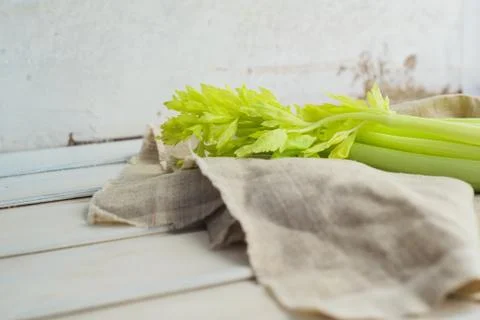 Raw fresh rustic concept, Celery on a white rag on the wooden background Stock Photos