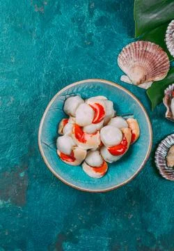 Raw fresh seafood shellfish scallops on blue background Stock Photos