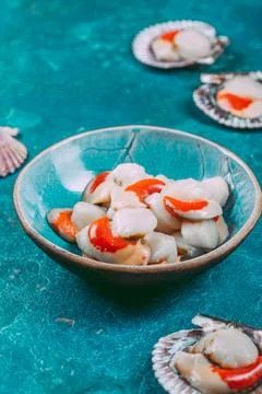 Raw fresh seafood shellfish scallops on blue background Stock Photos