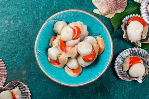 Raw fresh seafood shellfish scallops on blue background Raw fresh seafood ... Stock Photos