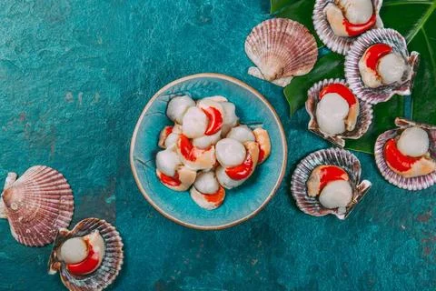 Raw fresh seafood shellfish scallops on blue background Raw fresh seafood ... Stock Photos