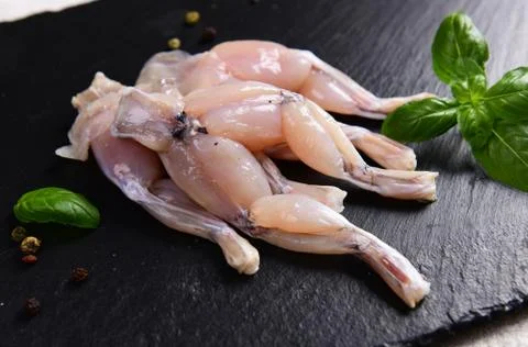 Raw frog legs Stock Photos
