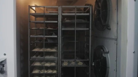 Raw frozen buns for burgers of white dough packed in transparent plastic bags in Stock Footage