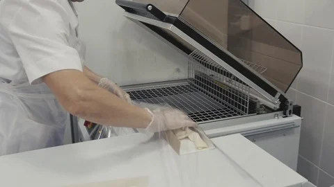 Raw frozen buns for burgers of white dough packed in transparent plastic bags in Stock Footage