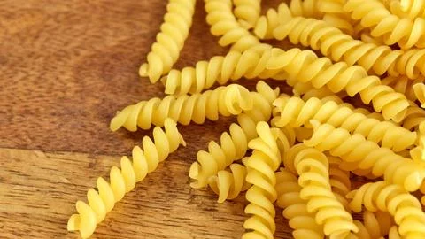 Raw fusilli pasta close-up, on a table Foto stock