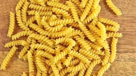 Raw fusilli pasta close-up, on a table Stock Photos