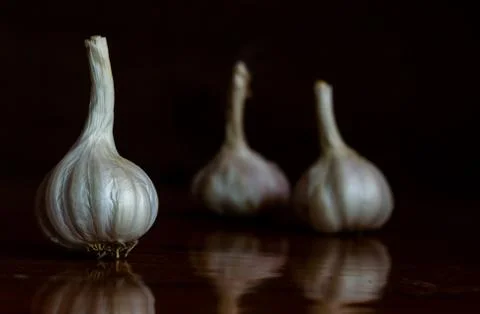 Raw Garlic kept on the table Stock Photos