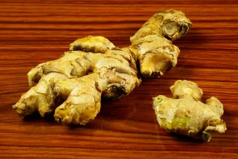 Raw Ginger pieces on the table Stock Photos