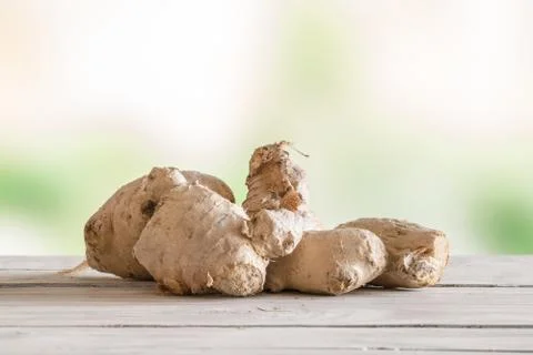 Raw ginger on a wooden table Stock Photos