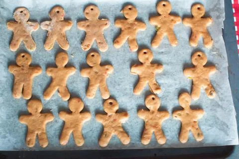 Raw gingerbread men on a baking Stock Photos