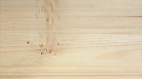 Raw grain buckwheat falling on table, slow motion. Top view Stock Footage 75490379