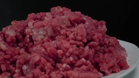 Raw Ground Beef Hamburger Meat on Plate with Black Background, Pan Left 動画素材 134322897