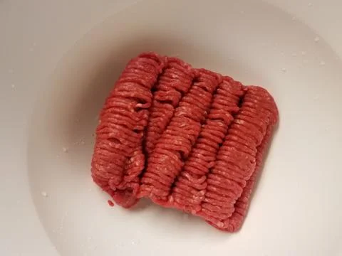 Raw ground beef meat in white container Stock Photos