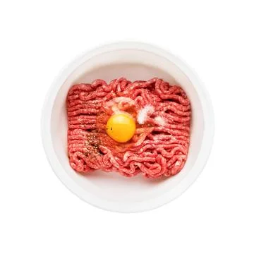 Raw ground beef, minced beef with egg and salt in a bowl isolated over white  Stock Photos