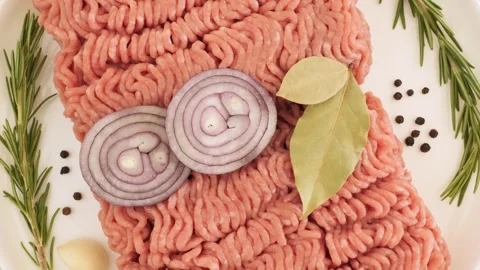 Raw ground meat with onion and spices rotating Stock Footage 337441308