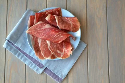 Raw ham. Raw marbled beef steaks on blue planks table Foto stock