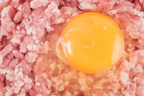 Raw hamburger with chicken egg close up Stock Photos