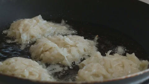 Raw hash browns spread in the pan Stock Footage 108006825