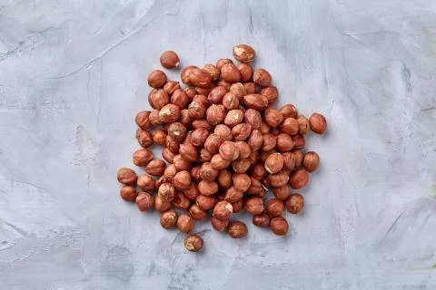Raw hazelnut on heap isolated on white background, selective focus, shallow Stock Photos