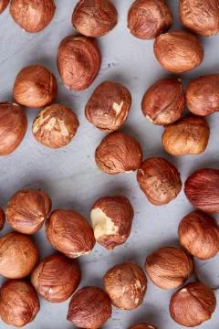 Raw hazelnut on heap isolated on white background, selective focus, shallow Stock Photos