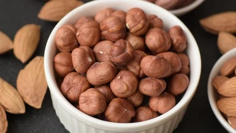 Raw hazelnuts without shells in a bowl Stock Footage 304490534