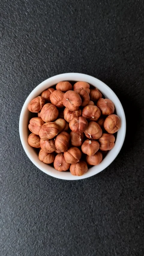 Raw hazelnuts without shells in a bowl Stock Footage 304490611