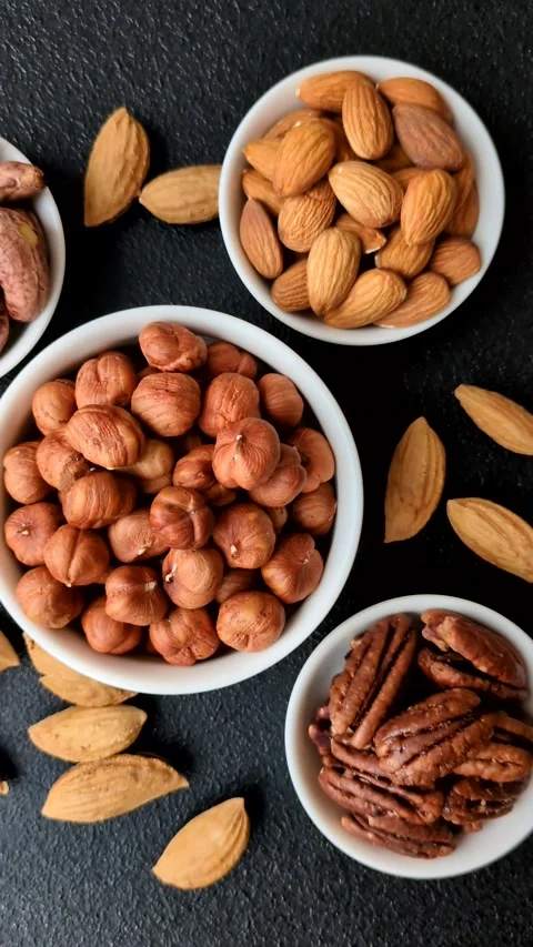 Raw hazelnuts without shells in a bowl Stock Footage 304490617