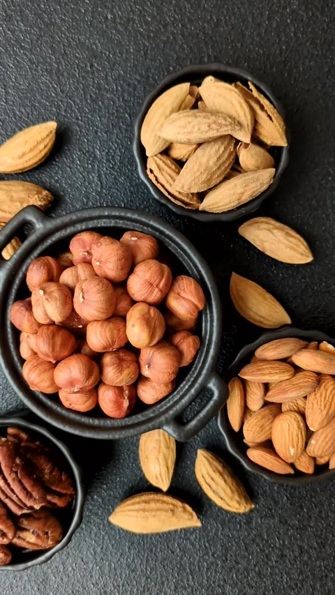 Raw hazelnuts without shells in a bowl Stock Footage 304490625