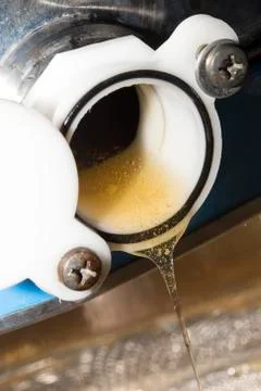 Raw honey go down from a container for the processing Stock Photos
